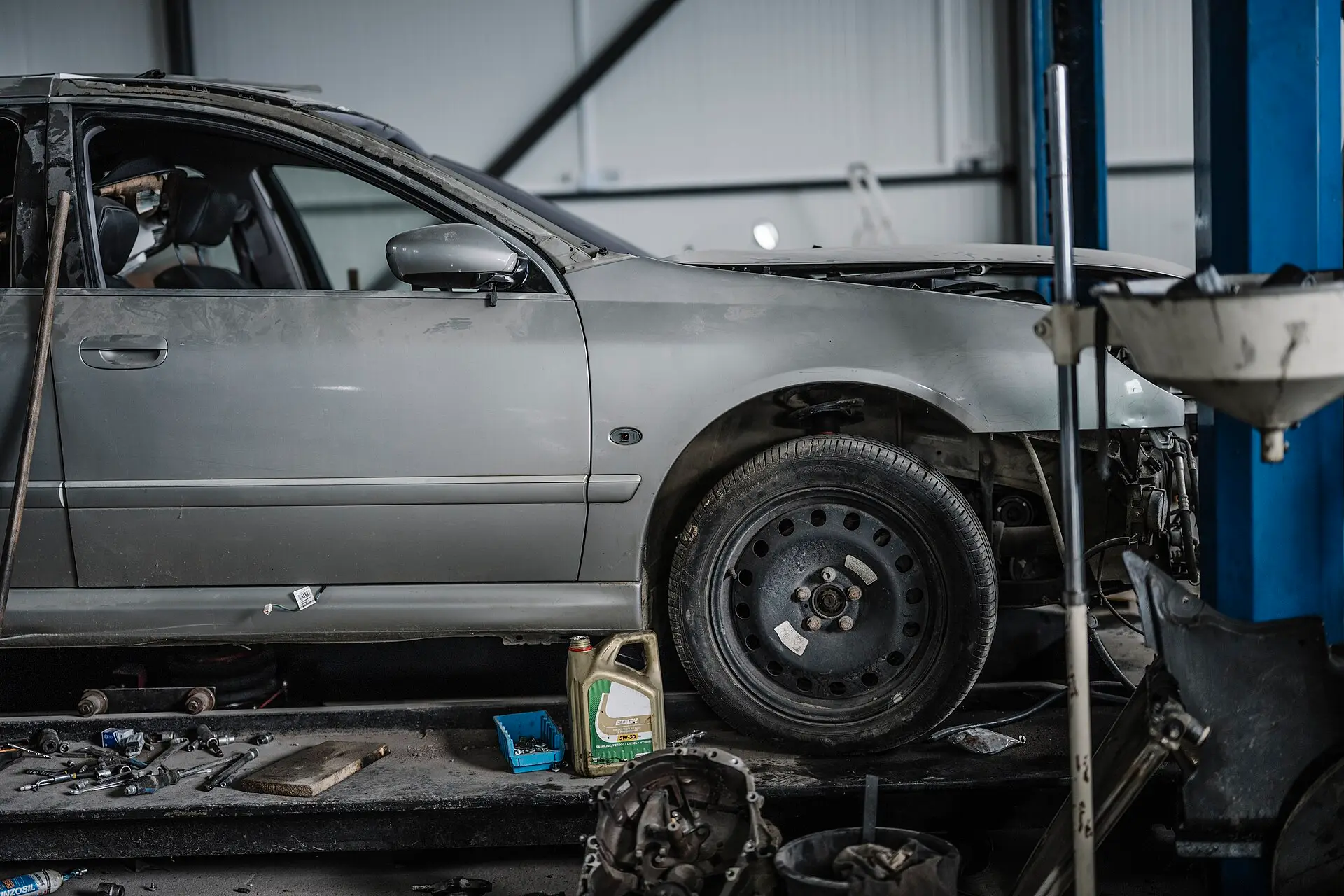 A car on a lift with its underside exposed